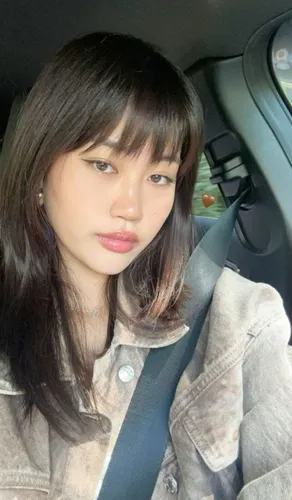 Try on this hairstyle which features straight hair with bangs partially covering the forehead.