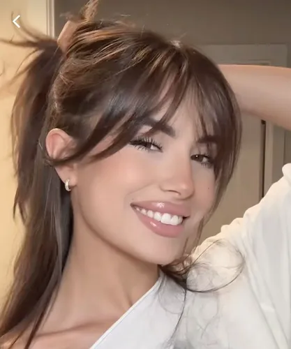 Try on a messy ponytail hairstyle with swept bangs.