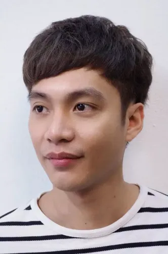 Try on a trendy short hairstyle with a softly textured top and natural side parting, ideal for a fresh and clean look.