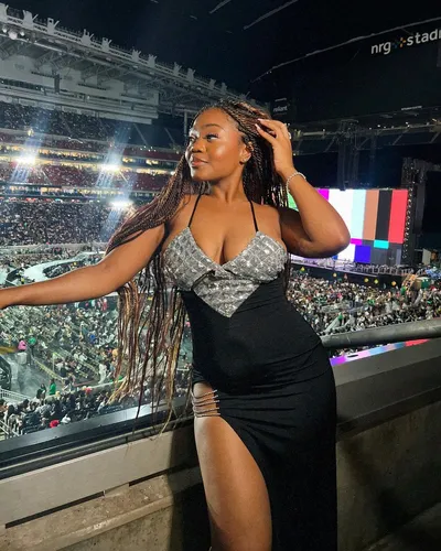 Try on this braided hairstyle that cascades gracefully over the shoulders, featured in a venue setting.