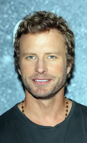 Try on this medium-length, curly hairstyle showcased on a person wearing a dark t-shirt, complemented with a subtle necklace.