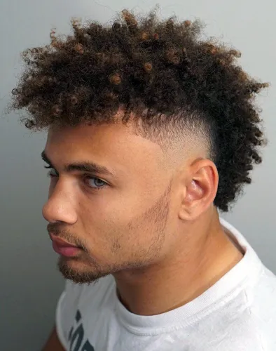 Try on this naturally curly hairstyle with tightly coiled patterns and twisted ends for a vibrant look.