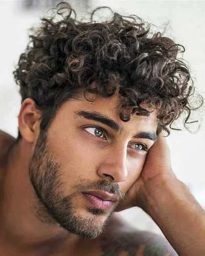 Try on a hairstyle with tight, voluminous curls, offering a casual yet trendy appearance.