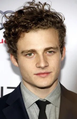 Try on this curly hairstyle that forms tightly coiled loops giving a voluminous appearance.