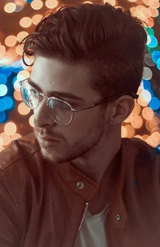 Try on this slicked back, wavy hairstyle