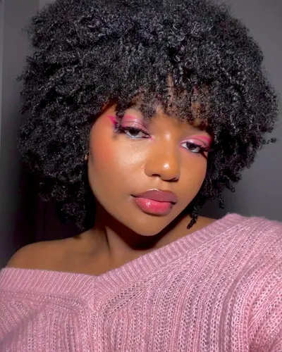 Try on this voluminous curly hairstyle featured in the image, ideal for capturing a stylish and youthful look.