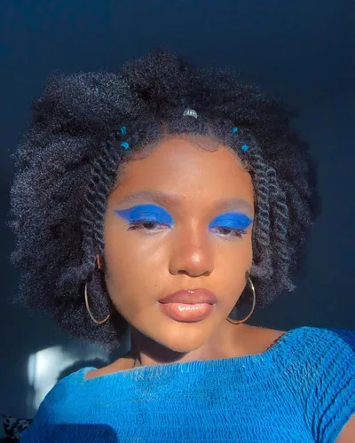 Try on this lush twist out hairstyle adorned with small beads adding a playful touch.