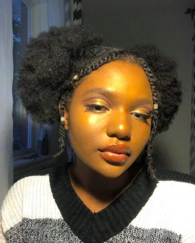 Try on a puff hairstyle, featuring voluminous twin puffs positioned on either side of the head, creating a symmetrical and playful look.