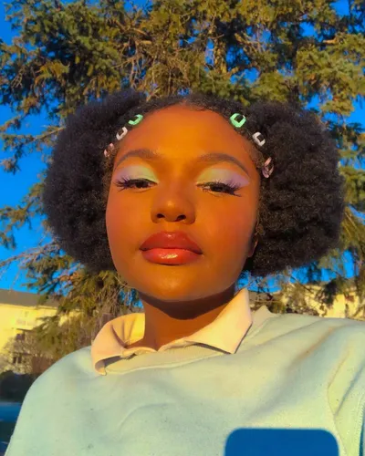 Try on an Afro hairstyle paired with a light blue top