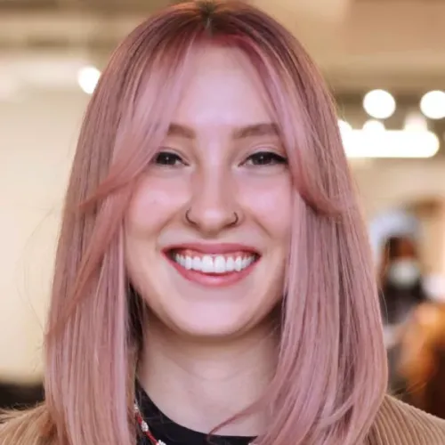 Try on this straight, medium-length pink hairstyle that features a sleek and even cut, complementing the cheerful facial expression.