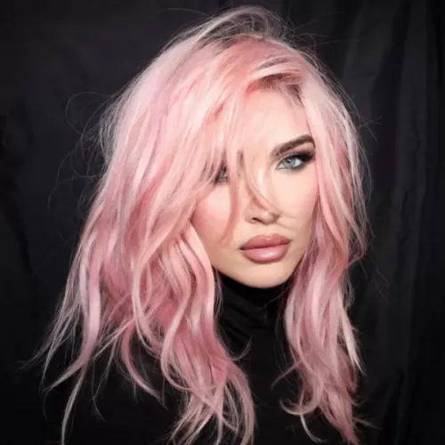 Try on this light pink, long, wavy hairstyle that gently frames the face, adding a touch of elegance and softness.