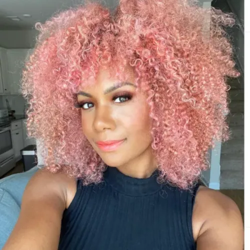 Try on this pink, voluminous curly hairstyle that frames the face beautifully.