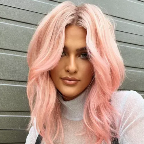 Try on this shoulder-length, wavy pink hairstyle with subtle layers to enhance volume and texture.