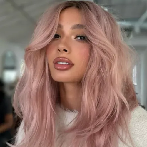 Try on this trendy long wavy pink hairstyle featured in the image.