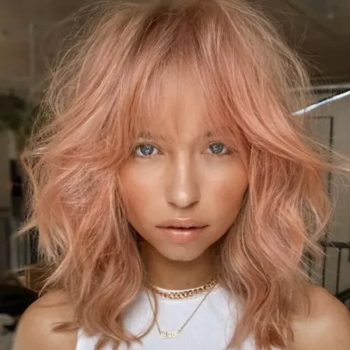 Try on this soft, wavy, medium-length pastel pink hairstyle.