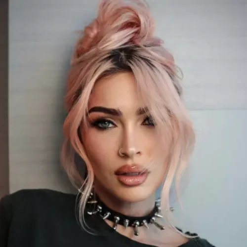 Try on a modern hairstyle featuring pink hair styled into a messy top bun with loose, face-framing strands.