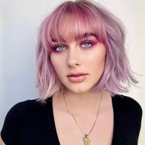 Try on this playful and trendy shoulder-length wavy hairstyle in a lavender hue, ideal for giving a touch of personality and fun to your look.