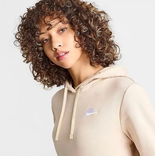 Try on a medium-length curly hairstyle, featuring tight curls with rich brown tones