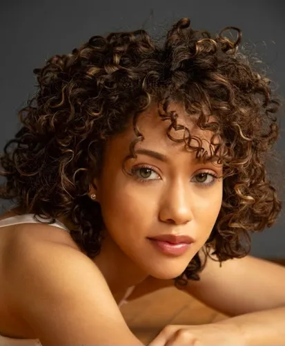 try on tight curly hairstyle with voluminous spirals cascading around the face