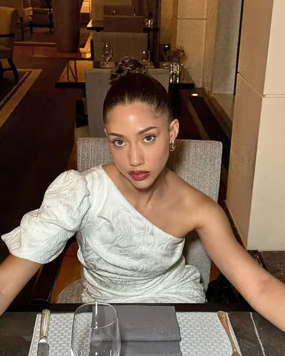 Try on a sleek bun hairstyle, neatly tied at the top of the head with a tidy and polished appearance.