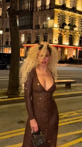 try on a long curly hairstyle, showcasing voluminous curls with a bouncy appearance, styled freely to cascade down around the shoulders