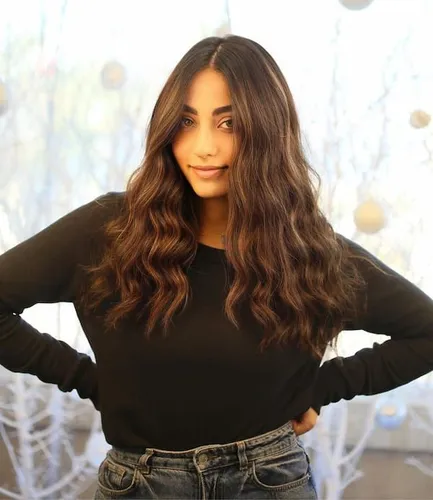 Try on this hairstyle featuring a woman with long wavy hair.