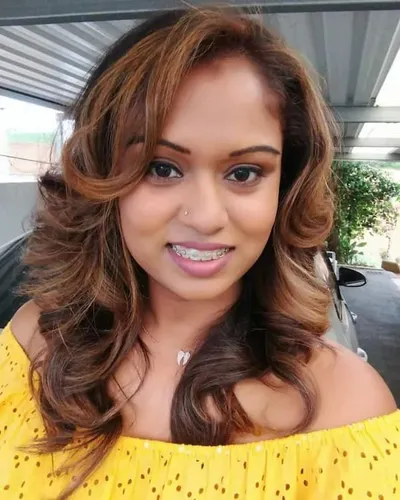 Try on a hairstyle featuring medium-length brown hair with soft curls, flowing elegantly around the shoulders.