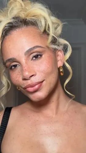 try on a casual messy bun hairstyle, accessorized with simple earrings