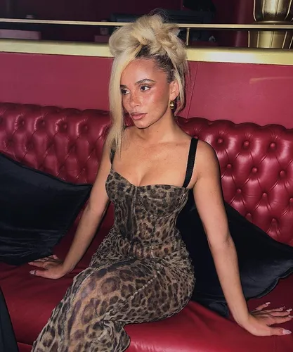 Try on a bold updo hairstyle featuring voluminous top sections gathered into large, loose twists or knots, adding an avant-garde touch to the look