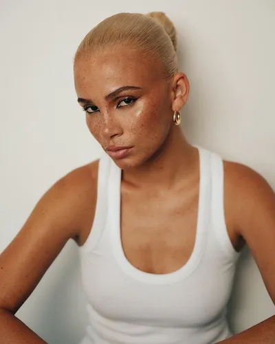 Try on this sleek bun hairstyle, perfectly accentuated with a few loose hairs for a smooth, refined look.