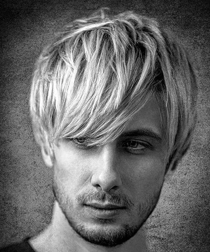 Try on this shaggy blonde layered hairstyle that sweeps across the forehead, blending into the soft layers around the face.