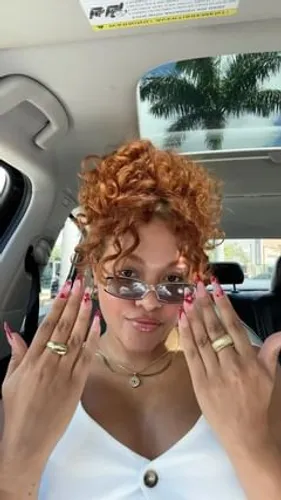 Try on this vibrant curly short hairstyle with a voluminous look.