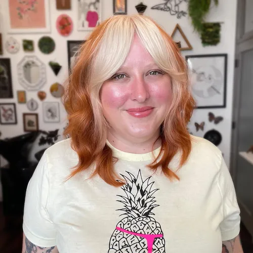 Try on this shoulder-length wavy hairstyle with natural ginger color, softly framing the face.