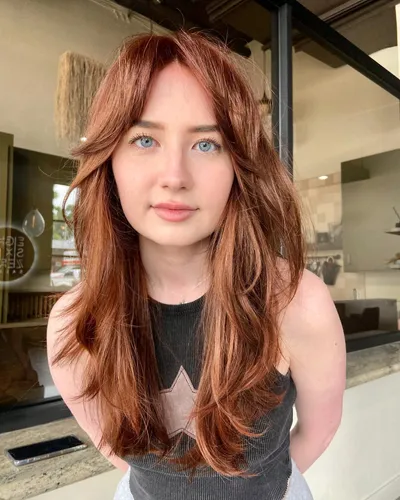 Try on this long wavy auburn hairstyle for a rich, voluminous look.