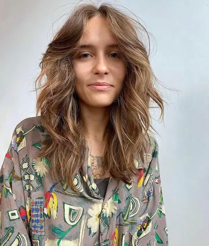 Try on this effortlessly chic medium-length wavy hairstyle, perfect for a casual yet stylish look.