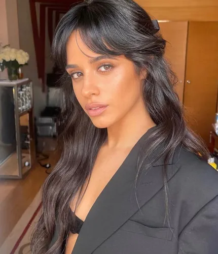 Try on this long wavy hairstyle with bangs, giving a soft and stylish look.