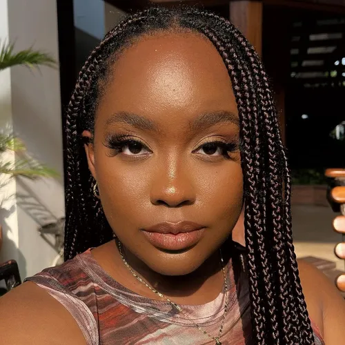 Try on this tightly braided hairstyle, featuring neat, small braids that frame the face elegantly.
