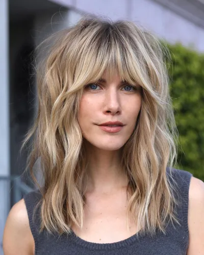 try on this trendy long, wavy hairstyle with subtle highlights, falling just past the shoulders.