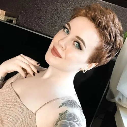 Try on this stylish short haircut, featuring a tousled, textured style with a soft, natural brown color. The hair is cropped close to the head with added volume and a slight wave, adding a modern and elegant touch.