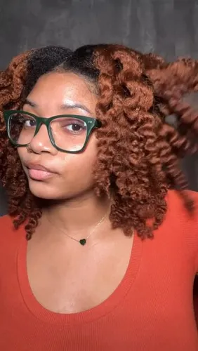 Try on a medium-length, lush curly hairstyle in a vibrant auburn shade.