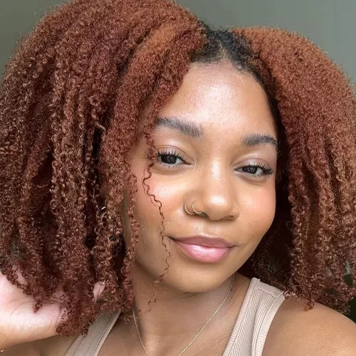 Try on this hairstyle with curly, ombre locks featuring tight curls in a blend of natural brown shades that transition to a lighter hue, framing the face beautifully.