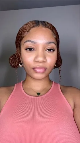 Try on this effortlessly chic hairstyle featuring a braided design with buns on each side of the head.