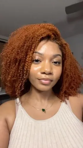 Try on this vibrant shoulder-length curly hairstyle in a striking copper tone, embodying a fresh and lively look.