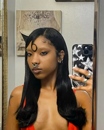 Try on this sleek, long straight hairstyle with a middle part and subtle waves at the ends. The hairstyle frames the face elegantly, enhancing the sophisticated look.