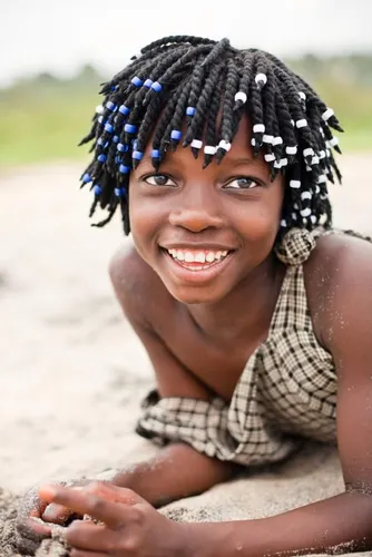 Try on this joyful hairstyle featuring short beaded twists decorated with blue and white beads, offering a playful and vibrant look.