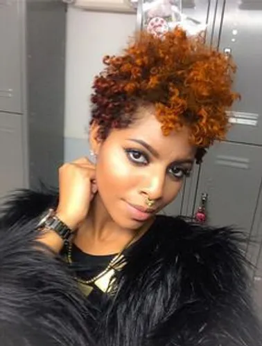 Try on this vibrant tinted curly hair paired with a short hairstyle, featuring warm brown to orange hues that enhance the curls