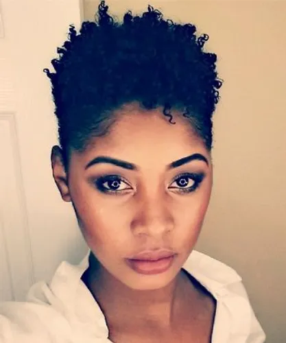 Try on this curly, tightly coiled hairstyle that appears well-maintained and voluminous.