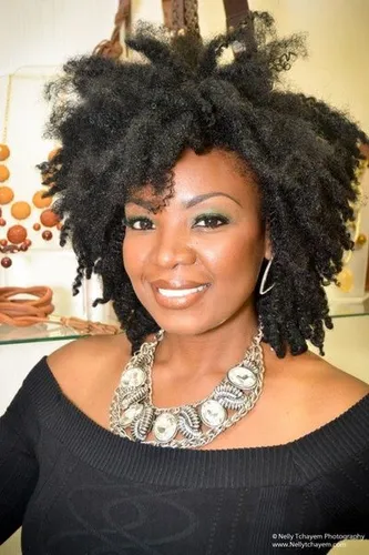 Try on this natural, voluminous short black hairstyle with defined, textured coils prominently styled to add a playful and dynamic look.