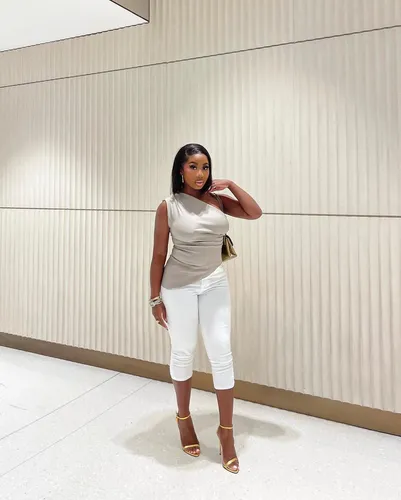 Try on a medium-length, straight hairstyle as seen on the woman in the image.