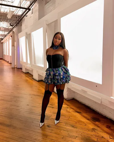 Try on this sleek straight hairstyle. The hair is parted in the middle and flows down elegantly, enhancing the sophisticated outfit.